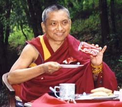 Lama Zopa Rinpoche offering food. Photo by George Propps.