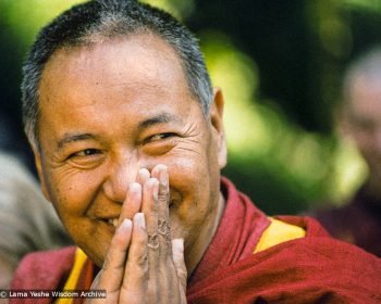 Lama Yeshe smiling with hands together in prostration mudra