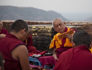 Lama Zopa Rinpoche giving the oral transmission of the Vajra Cutter Sutra on Vulture’s Peak, Bihar, India, March 2014. Photo by Andy Melnic.