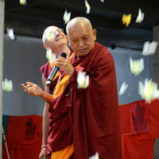 Flowers falling from above on Lama Zopa Rinpoche and Ven. Roger Kunsang following the public talk with Rinpoche, Great Stupa of Universal Compassion, Australia, September 20, 2014. Photo by Kunchok Gyaltsen.