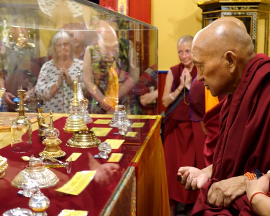 Lama Zopa Rinpoche viewing relics of Buddhist masters displayed in the newly remodeled relic room in the exhibition center at the Great Stupa of Universal Compassion,  Bendigo, Australia, October 2014. Photo by Ven. Roger Kunsang.
