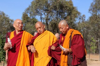 Lama Zopa Rinpoche being led into the long life puja.