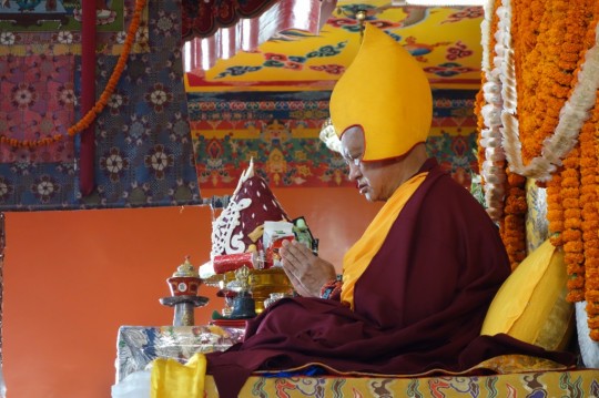 Lama Zopa Rinpoche reciting the names of the 35 Buddhas during a long life puja at Kopan Monastery, Nepal, December 2104. Photo by Ven. Roger Kunsang.