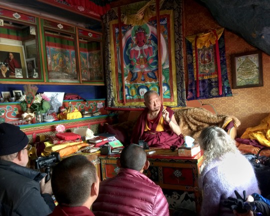 Lama Zopa Rinpoche talking about the previous Lawudo Lama in his meditation cave, Lawudo, Solu Khumbu, Nepal, April 2015. Photo by Ven. Roger Kunsang. 