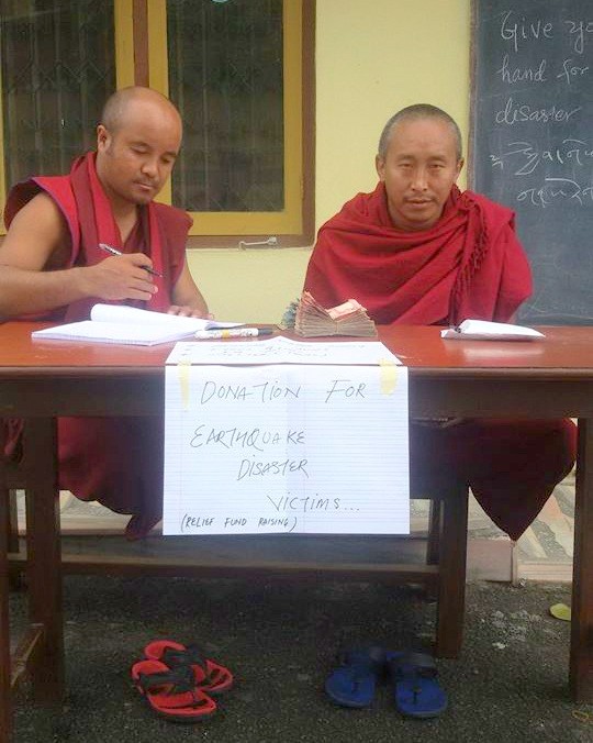 Monks receiving donations at Kopan Monastery, Nepal, April 29, 2015