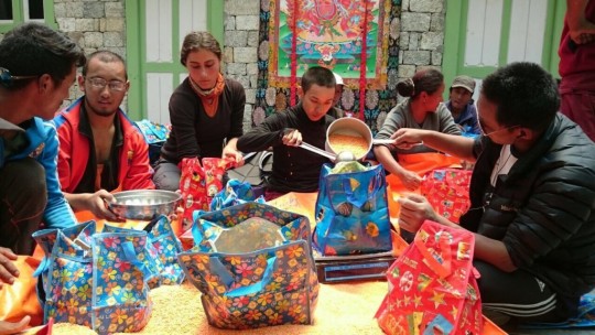 Charok Lama and other volunteers helping pack the packages of food to be delivered to Solu Khumbu villagers. 