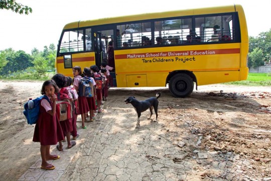 Children head to school on the bus the serves Tara Children's Project and the Maitreya School. Photo courtesy of Anye.