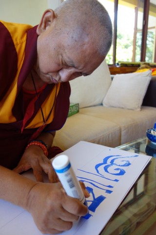 Lama Zopa Rinpoche writing mantras to go above a rabbit house located at Sera Je Monastery, India. Photo by Ven. Roger Kunsang, December, 2013.