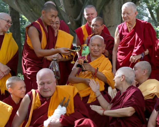 Lama Zopa Rinpoche holding Teddy Tulku during a group photo with Sangha at the end of the lam-rim retreat in Mexico, September 2015. Photo by Ven. Thubten Kunsang.