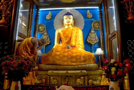 Robes offered to the Buddha statue in Mahabodhi temple, Bodhgaya, India, through the Puja Fund. July, 2015. Photo by Andy Melnic.