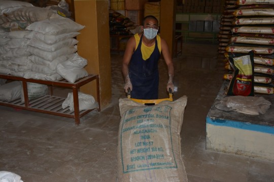 A monk from the Sera Je Food Fund Kitchen helps with flour needed for bread for 30,000. 