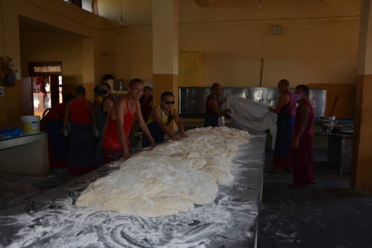 Volunteer monks help kneed the dough required for massive amounts of bread. 