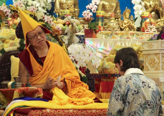 Lama Zopa Rinpoche and Tenzin Osel Hita at long life puja at Amitabha Buddhist Centre, Singapore, March 13, 2016. Rinpoche is offering Osel a gift of a crystal Buddha statue.