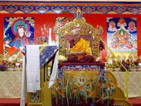 Lama Zopa Rinpoche teaching at the rented venue in Penang, Malaysia, March 2016. Photo by Ven. Lobsang Sherab. Chokyi Gyaltsen Center organized the teaching and arranged the incredible altar behind Rinpoche.