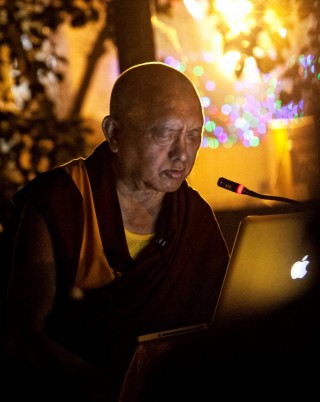 Lama Zopa Rinpoche reciting the Sutra of Golden Light at Mahabodhi Stupa, Bodhgaya, India, March 2014, Photo by Andy Melnic.