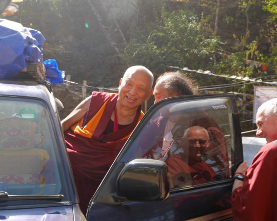 Lama Zopa Rinpoche, with the assistance of Osel Dorje Rinpoche, departing from Maratika Caves, Nepal, Febraury 2016. Osel Dorje Rinpoche is a famous Nyingma lama and teacher of His Holiness the Dalai Lama. Photo by Ven. Lobsang Sherab.