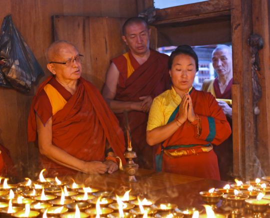 Rinpoche and Khado-la offering butter lamps at Kyichu Lhakhang, Bhutan, May 2016. Photo by Ven. Lobsang Sherab.