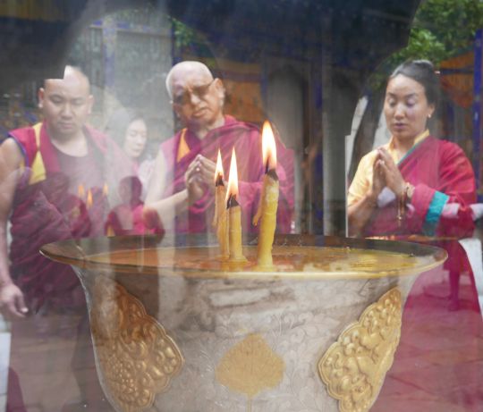 Rinpoche and Khado-la offering a butter lamp at Kyichu Lhakhang, Bhutan, May 2016. Photo by Ven. Roger Kunsang. 