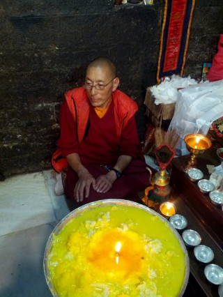The butter lamp offered to the self-emanating Chenrezig statue will burn as long as the statue remains. 