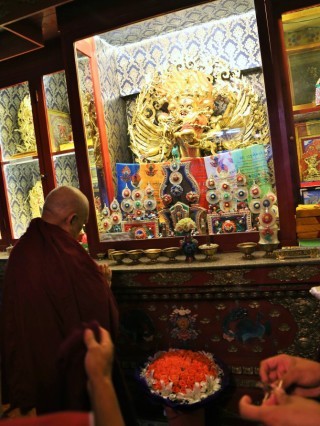 Lama Zopa Rinpoche making offerings to the Hayagriva statue on the altar at Idgaa Choizinling College in Mongolia.