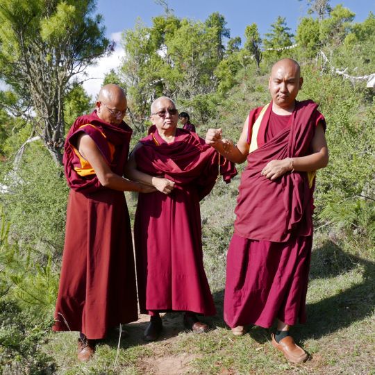Lama Zopa Rinpoche with Geshe Tenzin Khenrab (left) and Ven. Tendar walking down to  Drakarpo in Paro, Bhutan, June 2016. Photo by Ven. Roger Kunsang. 