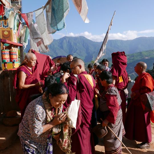 Lama Zopa Rinpoche offering blessing strings and Namgyalma protections at Drakarpo, Bhutan, June 2016