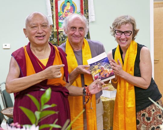 Lama Zopa Rinpoche with Nicholas Ribush and Wendy Cook of the Lama Yeshe Wisdom Archive, Black Mountain, North Carolina, US, August 2016. Nick and Wendy are presenting Rinpoche with a copy of Rinpoche's new book Sun of Devotion, Stream of Blessings, just published by the Archive. Photo by Ven. Roger Kunsang.