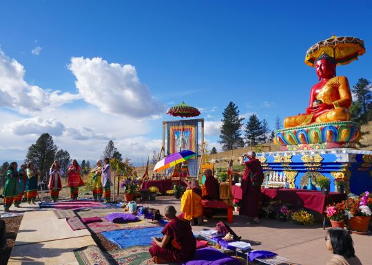 Rinpoche and festival attendees watch the Tara dance offering