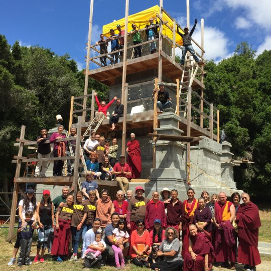 Land of Medicine Buddha community filing the ninth and final structural chamber of the Mahabodhi stupa.