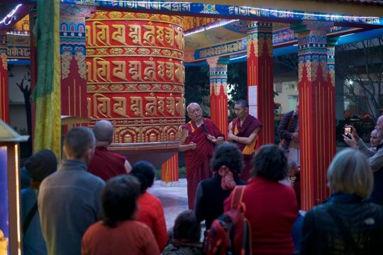 Lama Zopa Rinpoche at the Root Institute next to the large prayer wheel. Photo by Bill Kane. 