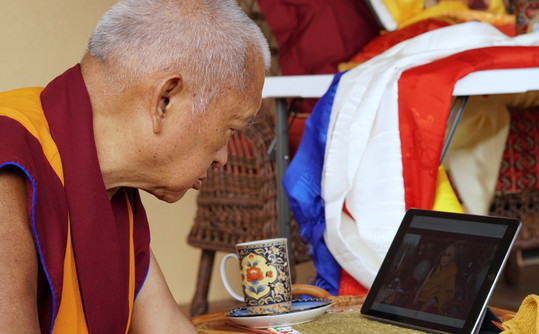 Lama Zopa Rinpoche watching His Holiness the Dalai Lama on an iPad, Taos, New Mexico, USA, July 2017. Photo by Ven. Lobsang Sherab.