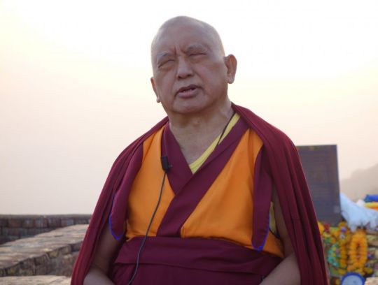 Lama Zopa Rinpoche teaches on the Heart Sutra as the sun begins to set, Vulture's Peak, Rajgir, India, February 2014. Photo by Ven. Roger Kunsang.