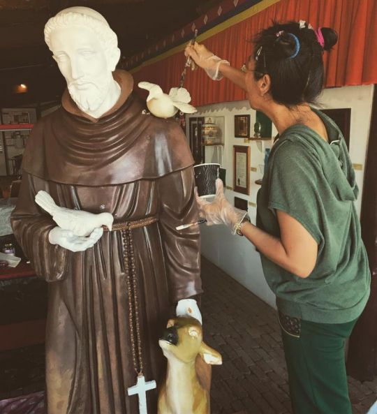 Lucy Wang painting the Saint Francis of Assisi statue, Bendigo, Australia, May 2018. Photo courtesy of The Great Stupa's Instagram page.