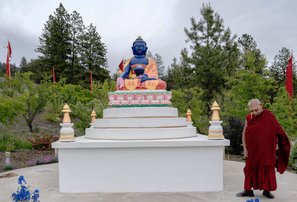 Lama Zopa Rinpoche circumambulating Medicine Buddha statue