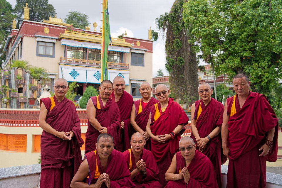 lama zopa rinpoche with senior monks standing in front of the monastery's main gompa