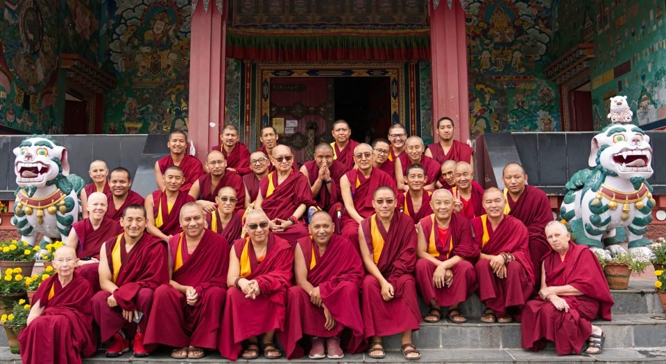 Rinpoche and Sangha sitting on steps of Kopan Gompa