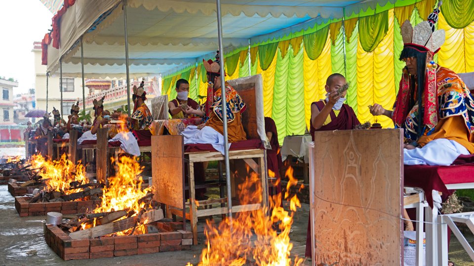 lamas doing fire puja outside