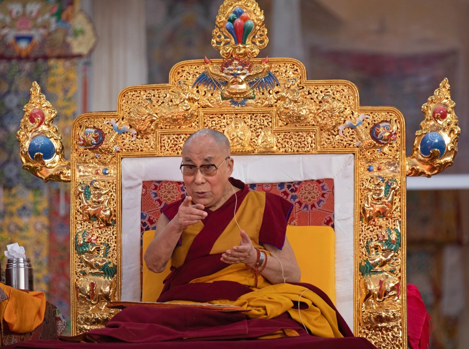 His Holiness the Dalia Lama giving a teaching on his golden decorated throne