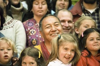 Lama Yeshe smiling, surrounde by children