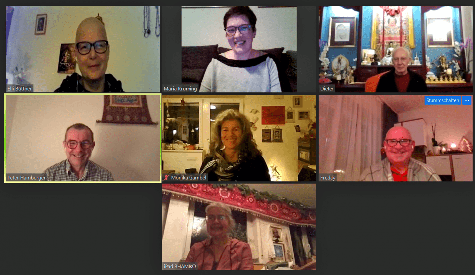 Seven smiling people on Zoom.