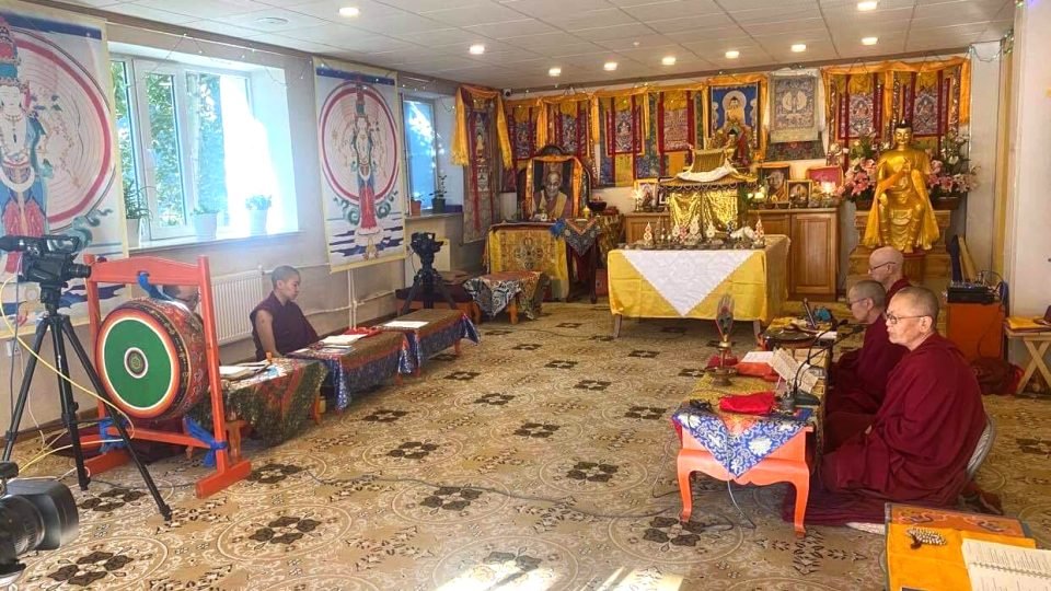 retreat participants sitting in a small gompa
