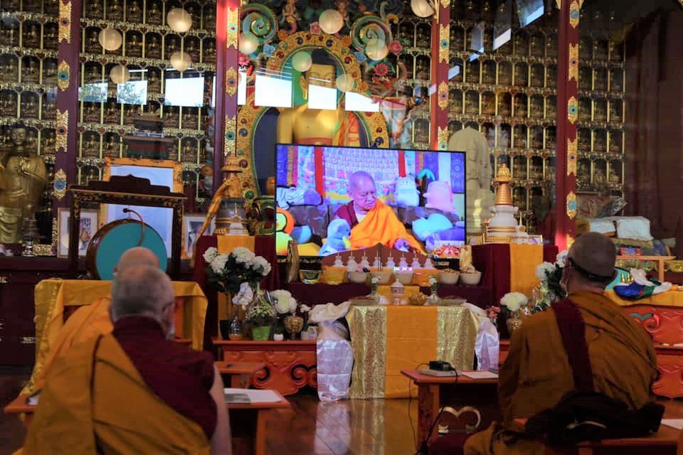 Lama Zopa Rinpoche on video screen on an altar at Nalanda Monastery
