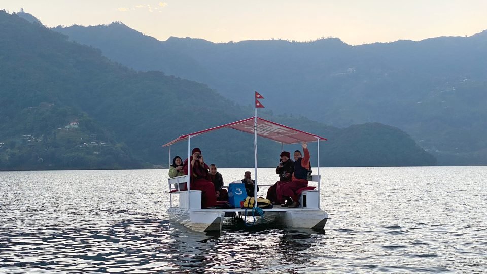 covered pontoon boat on lake