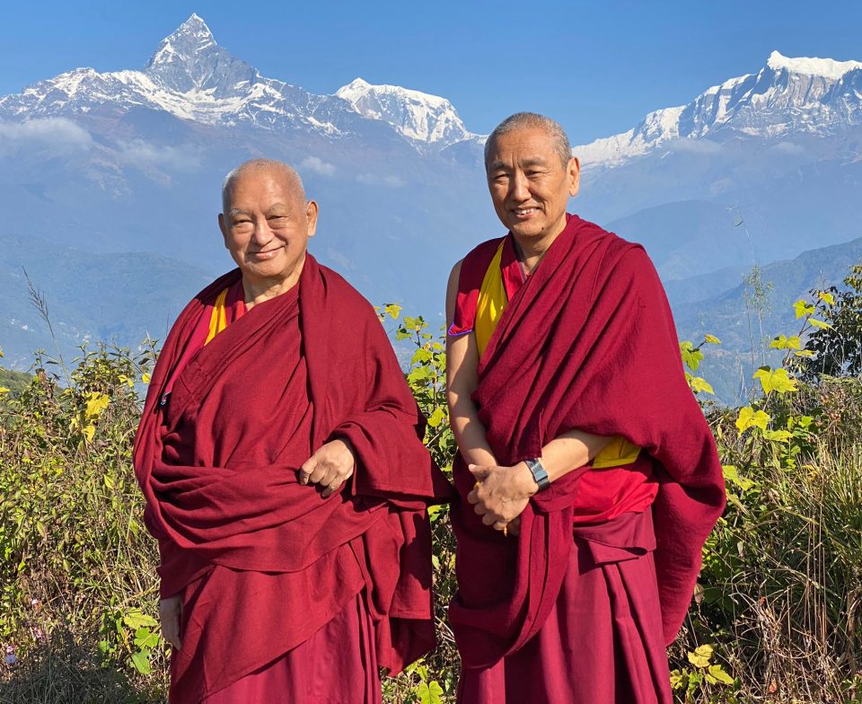 Lama Zopa Rinpoche and Khen Rinpoche Geshe Chonyi standing with the Annapurna Mountain Range in the background