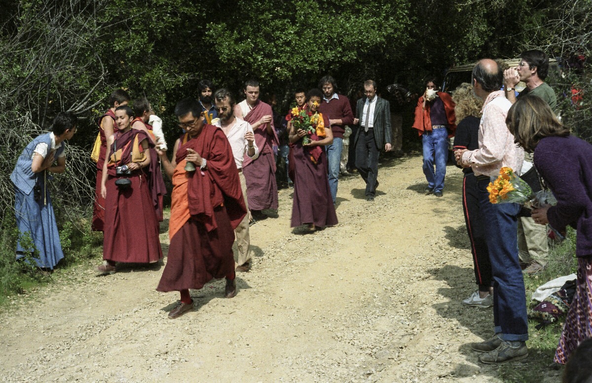 Lama Zopa Rinpoche leading the procession to the cremation of Lama Yeshe, followed by Mummy Max, Massimo Corona and other students. Vajrapani Institute, California, March, 1984. Age Delbanco (Babaji) (Photographer)