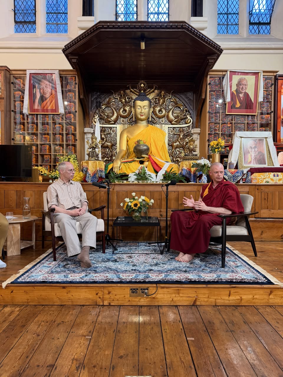 Geshe Tenzin Namdak, in conversation with Professor Murray Shanahan. JBC London, June 2026. Photo by JBC