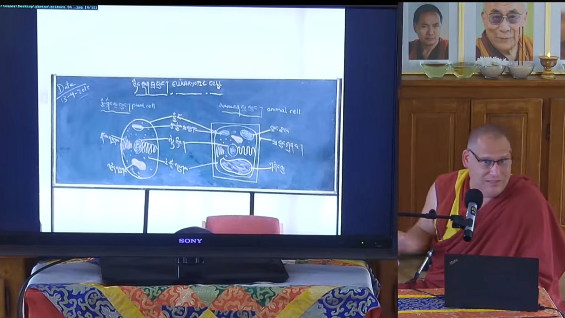 Geshe Tenzin Norbu during the “Dialogue Between Science and Buddhism” on “The Nature of Life” at Nalanda Monastery, France, May 9, 2026. Photo courtesy of Nalanda Monastery Youtube channel.