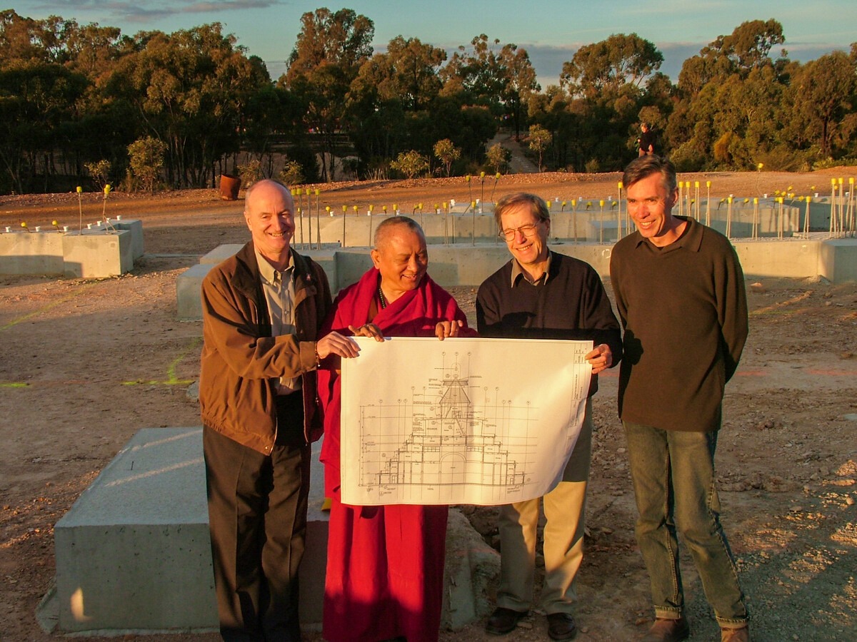 Lama Zopa Rinpoche with Ian Green, holding the blue print for the Great Stupa, Australia 2006. Photo of Ven. Roger
