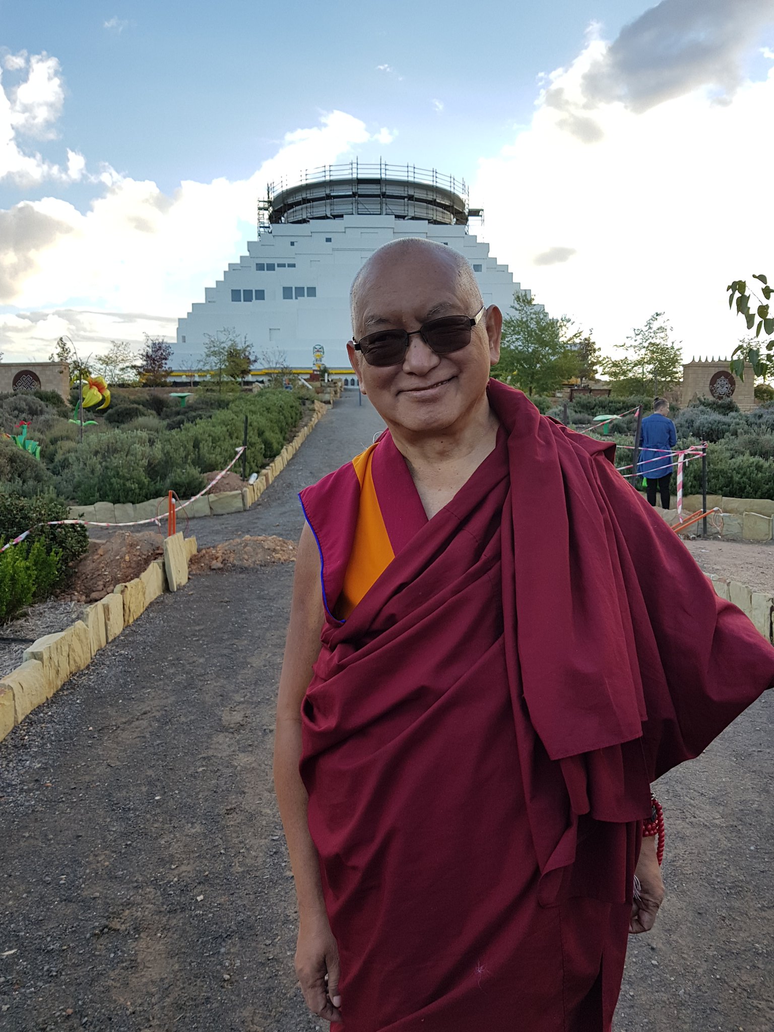 Lama Zopa Rinpche infront The Great Stupa of Universal Compassion, 2018. Photo Courtesy of Ian Green.