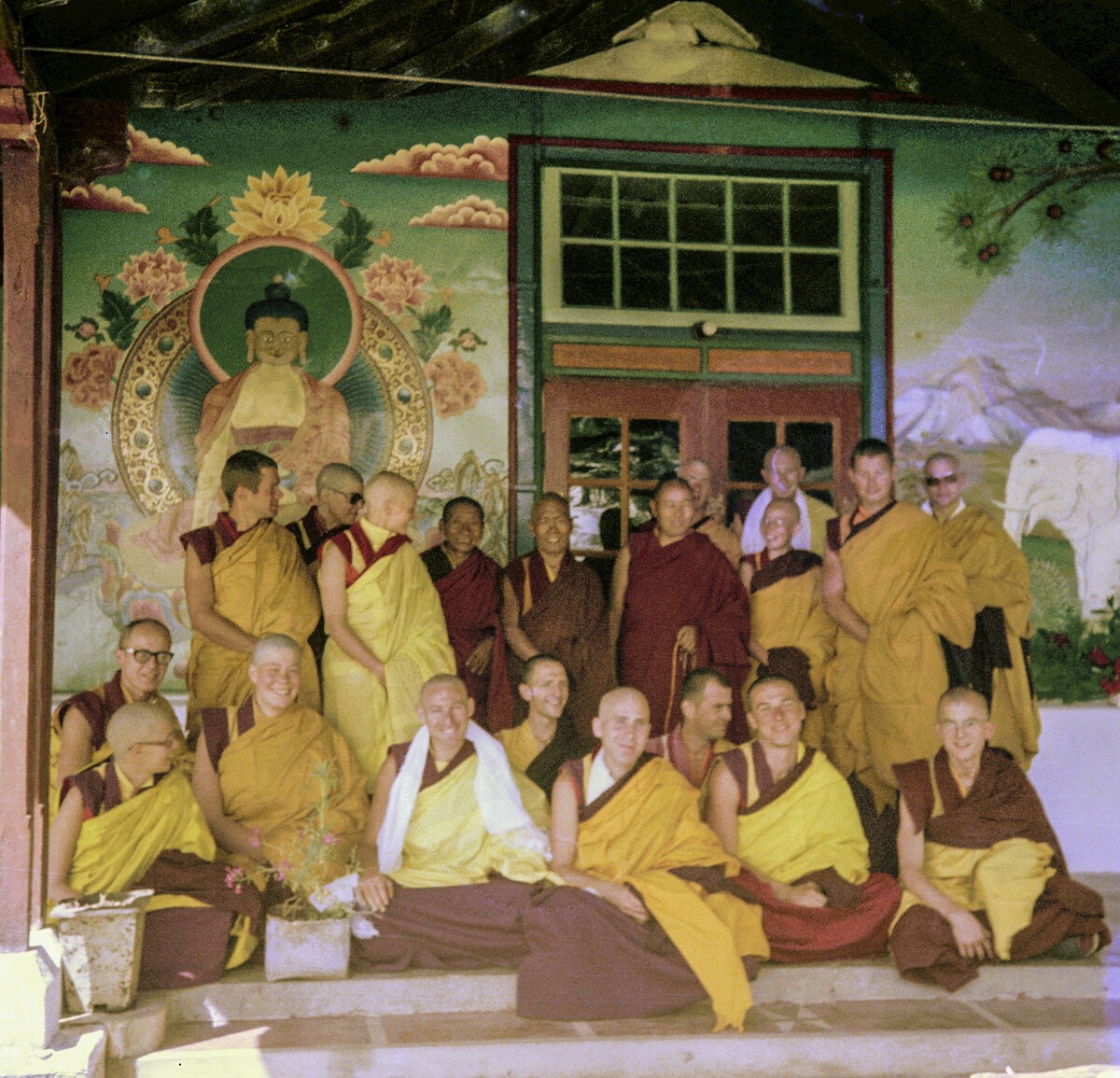 Lama Yeshe with newly ordained monks at Tushita Meditation Centre in 1976. Among them are Scott Brusso, holding a khata in the front row; Ven. Elisabeth Drukier; Adrian Feldmann (Thubten Gyatso); Angeles de la Torre; Dieter Kratzer; George Churinoff; John Feuille; Karin Valham; Margaret McAndrew; Pende Thubten (Jim Dougherty); Peter Kedge; and Ven. Roger Kunsang. Photo courtesy of LYWA.